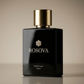 Black Rosova perfume bottle with gold cap on a beige background