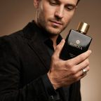 Man holding a black Rosova perfume bottle in a blurred indoor setting